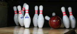 Bowling ball knocking down pins